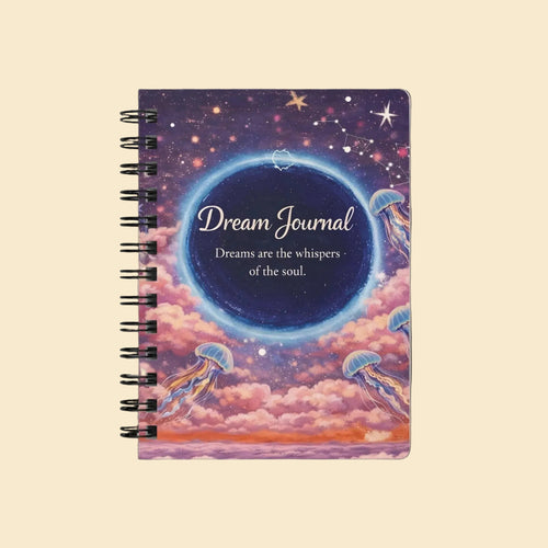 A spiral-bound dream journal with a cosmic jellyfish cover design, featuring the text 'Dream Journal' and 'Dreams are the whispers of the soul' on a soft cream background.