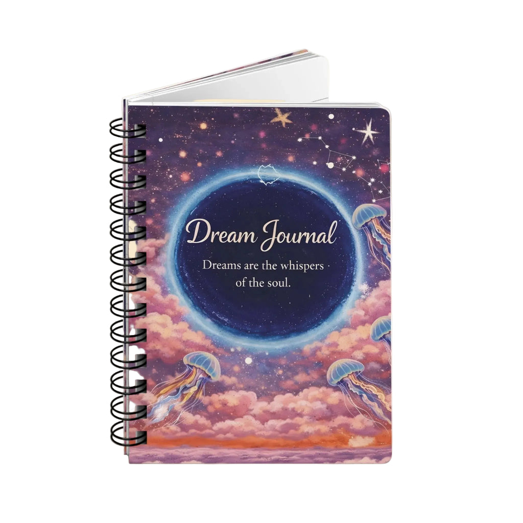A spiral-bound dream journal with a colorful cover illustration of a starry night sky, wormhole, pink clouds, and jellyfish. The cover features the text 'Dream Journal' and 'Dreams are the whispers of the soul.