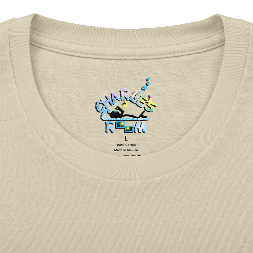 Close-up of a cream-colored t-shirt neck label featuring a colorful graphic that reads 'CHARLIE'S COZY ROOM' with a crown and small text below reading '100% Cotton Made in Mexico'.