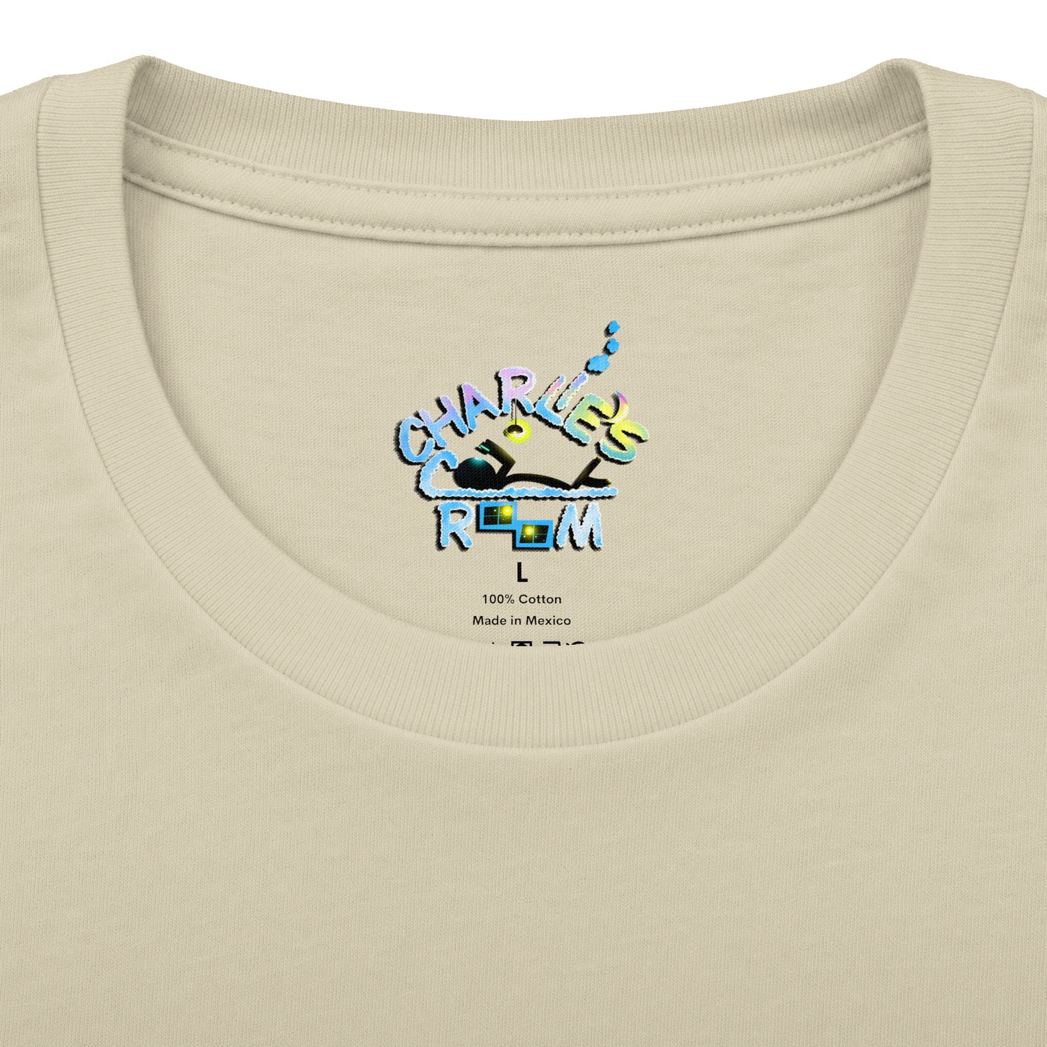 Close-up of a cream-colored t-shirt neck label featuring a colorful graphic that reads 'CHARLIE'S COZY ROOM' with a crown and small text below reading '100% Cotton Made in Mexico'.