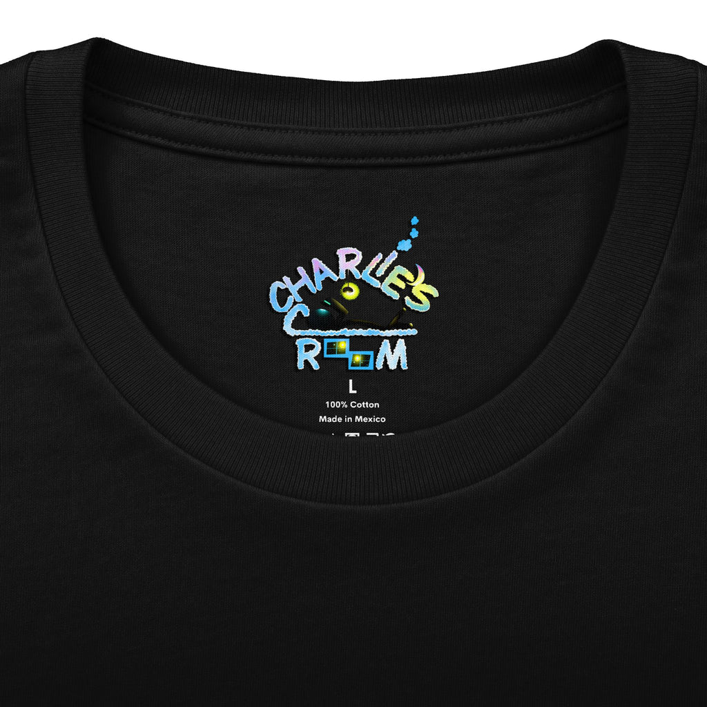 Close-up of a black crewneck t-shirt showing the inner neck label with a colorful graphic that reads 'CHARLE'S COZY ROOM' and small text below indicating '100% Cotton Made in Mexico'.