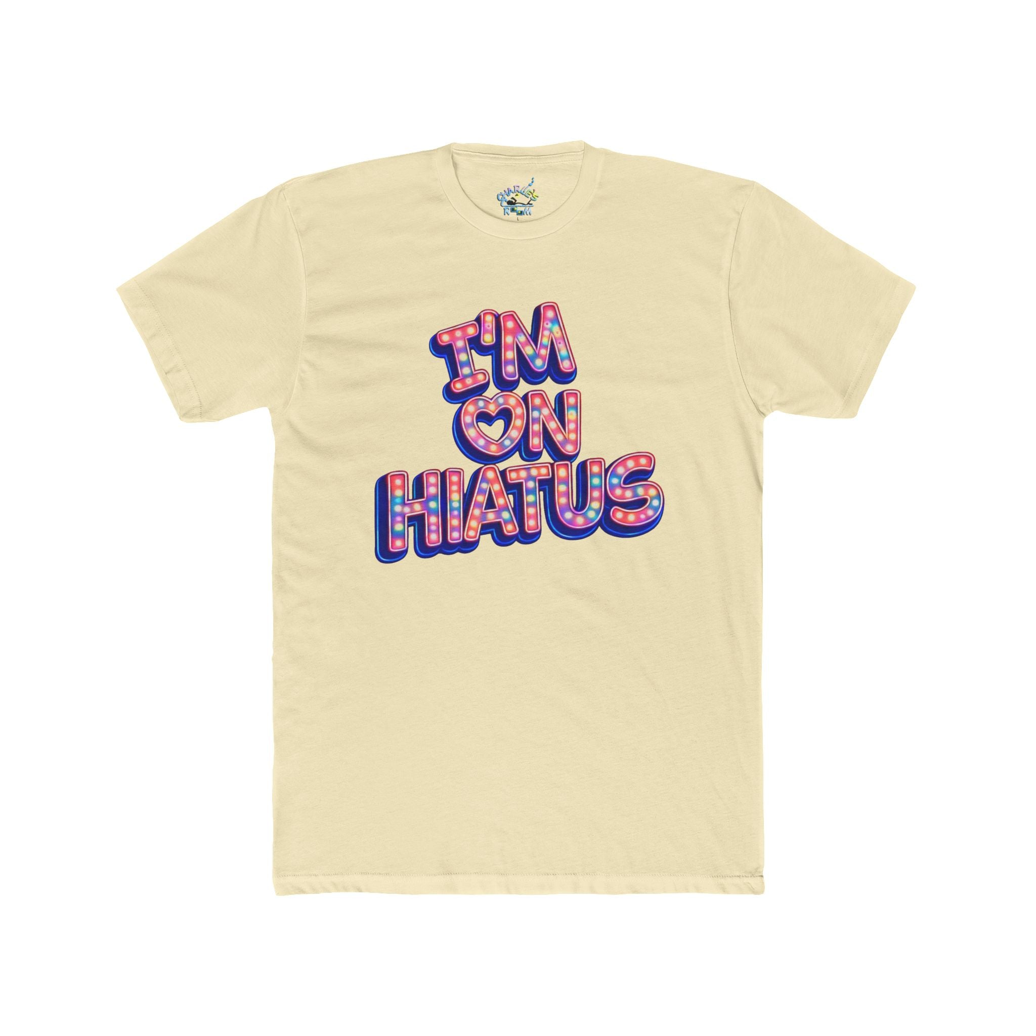 A pale cream-colored short-sleeve t-shirt with a colorful graphic on the chest reading 'I'M ON HIATUS' in a retro 3D bubble font with red, pink, and blue outlines.