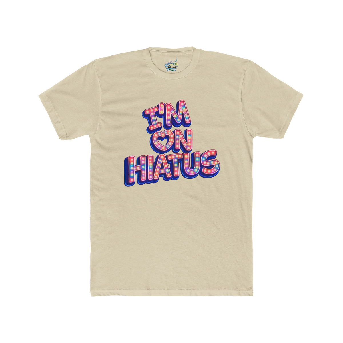A beige crewneck t-shirt with a colorful graphic on the chest that reads 'I'M ON HIATUS' in a retro 3D bubble font with a red, white, pink,  and blue patterned fill.
