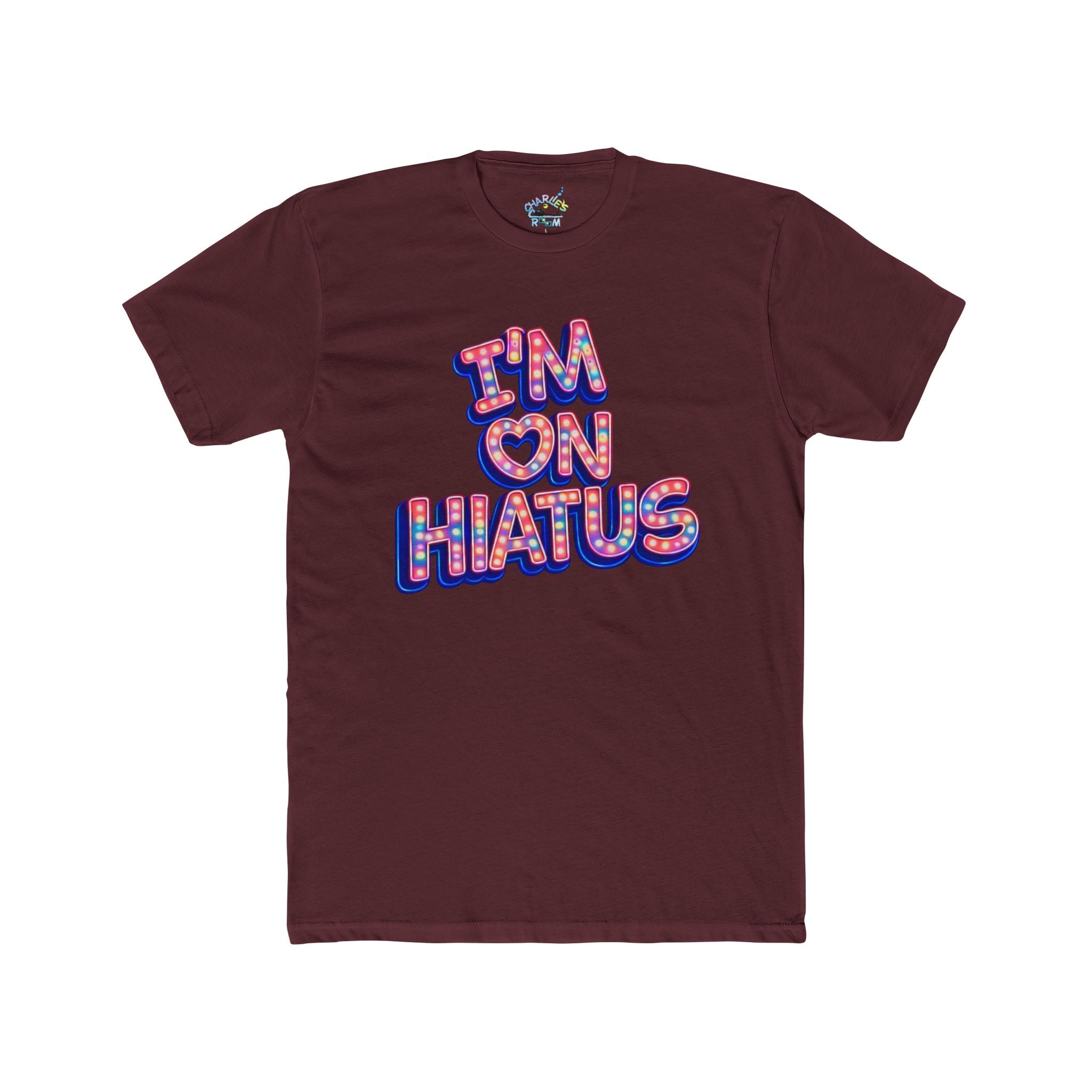 A maroon short-sleeve t-shirt with a graphic on the chest reading 'I'M ON HIATUS' in a retro bubble font with a red, white, pink, and blue pattern and a blue shadow effect. The shirt is displayed flat against a solid white background.