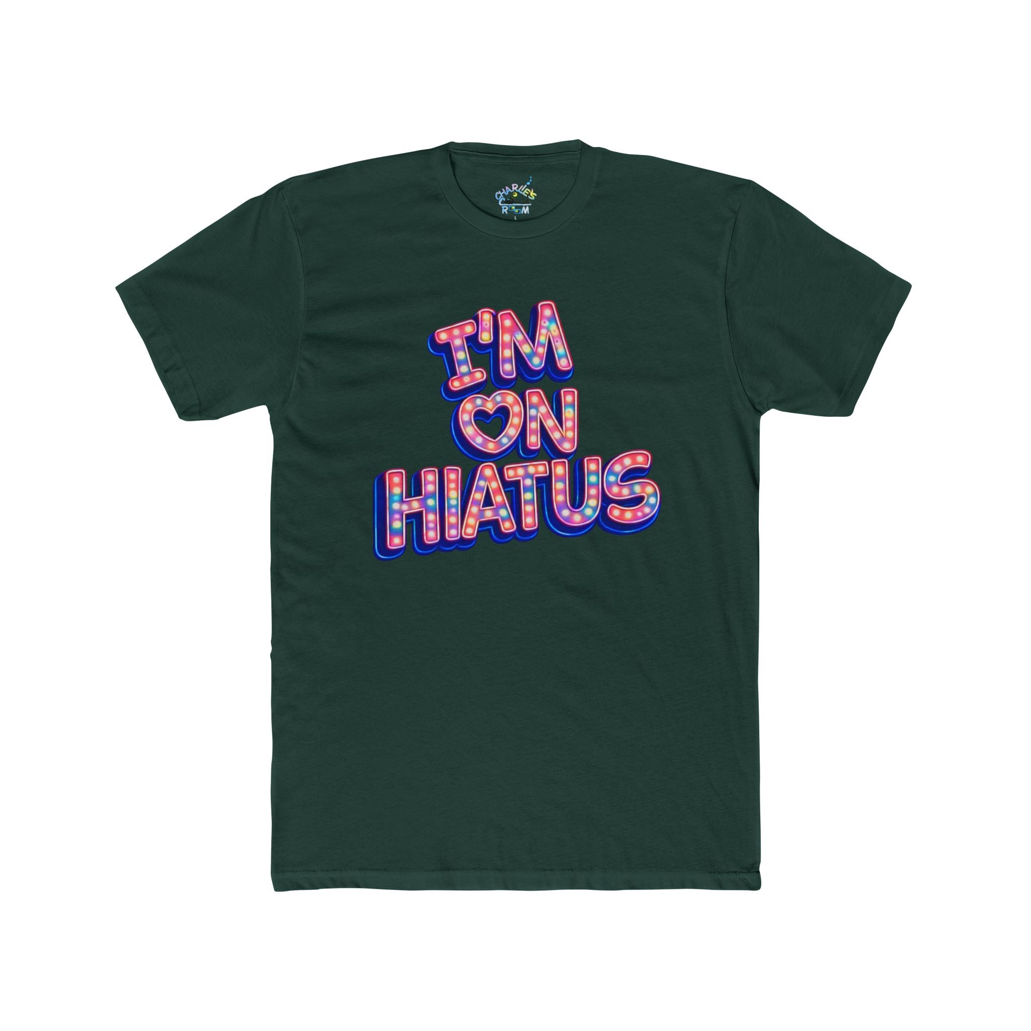 A dark green crewneck t-shirt featuring a colorful graphic on the chest that reads 'I'M ON HIATUS' in a retro bubble font with a red, white, and blue pattern and a small heart symbol.