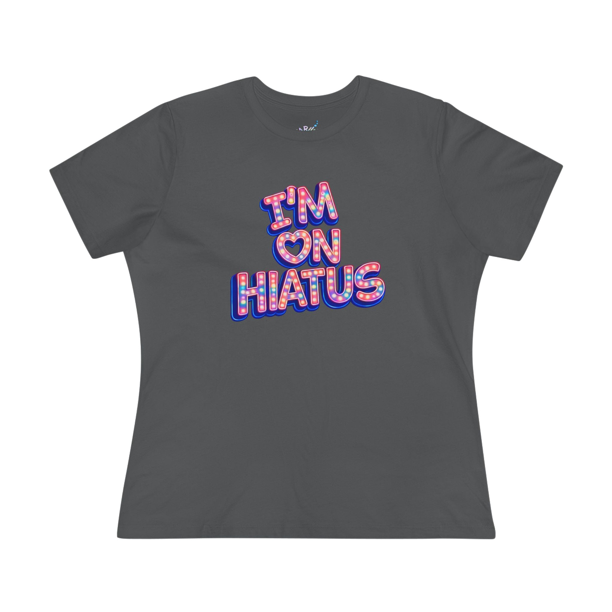 A dark gray short-sleeve t-shirt with a graphic text print reading 'I'M ON HIATUS' in a pink, red, and blue patterned bubble font, displayed on a clean white background.