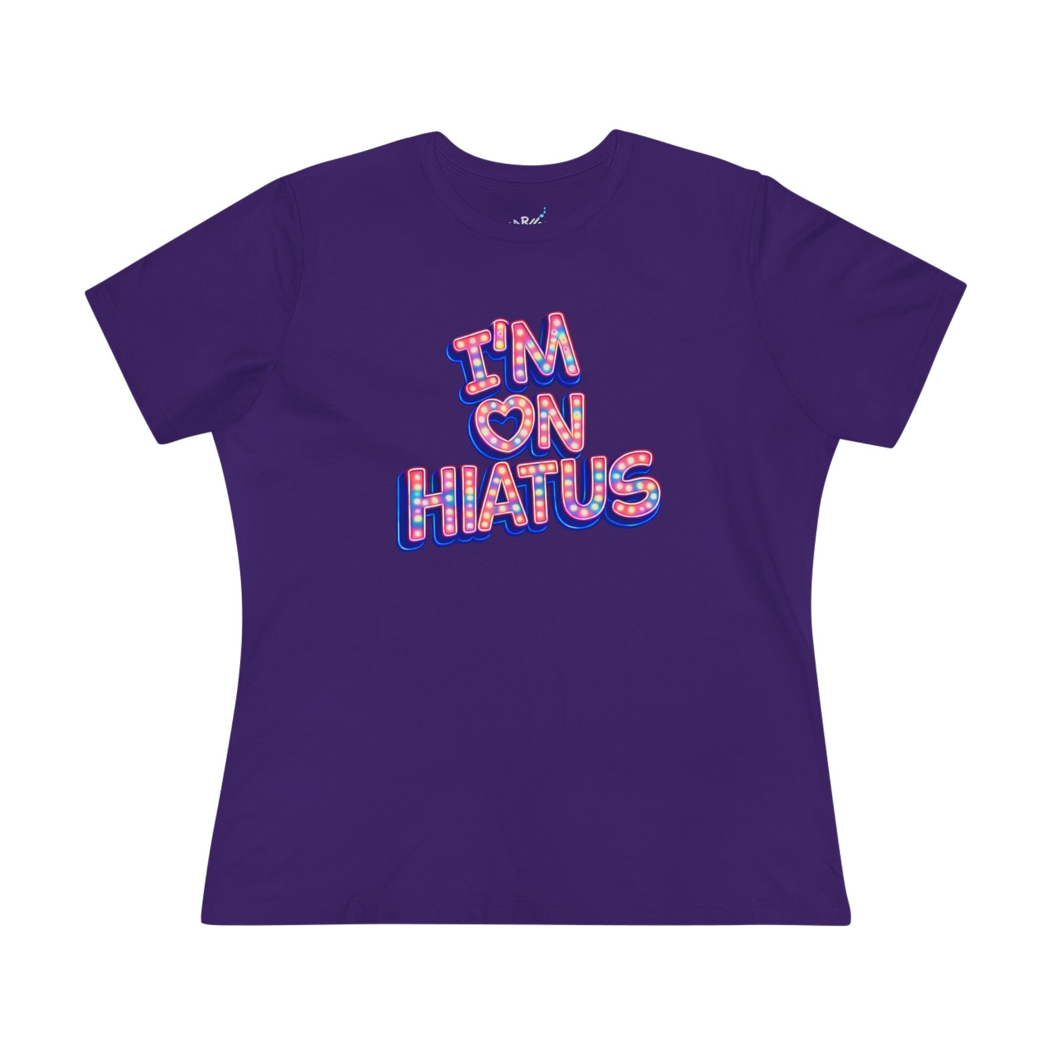 A purple short-sleeve t-shirt with a graphic on the front that reads 'I'M ON HIATUS' in a red, white, pink, and blue patterned font, displayed on a solid white background.